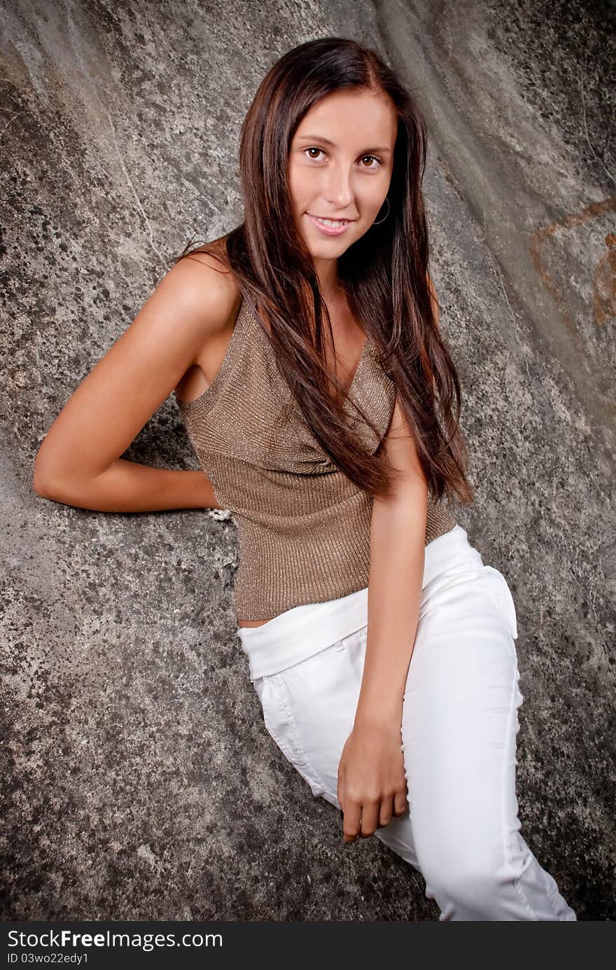 Happy young model next to concrete.