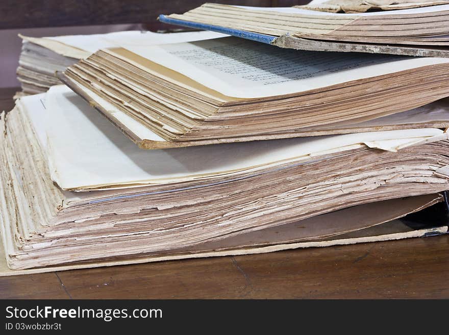 Stack of old books on wooden table