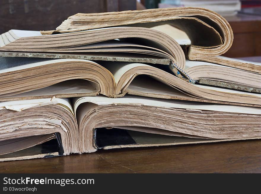 Stack of old books on wooden table