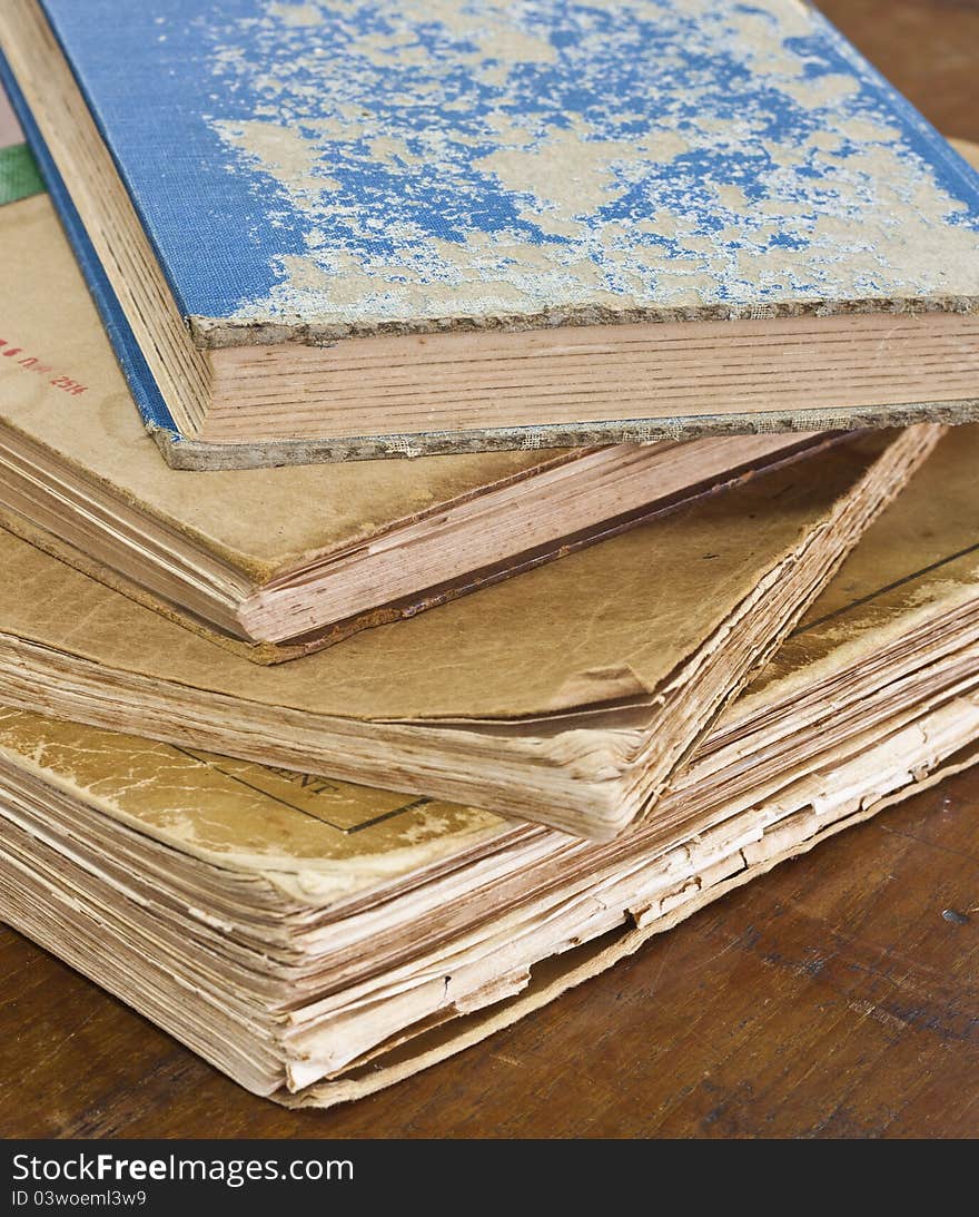 Stack of old books on wooden table