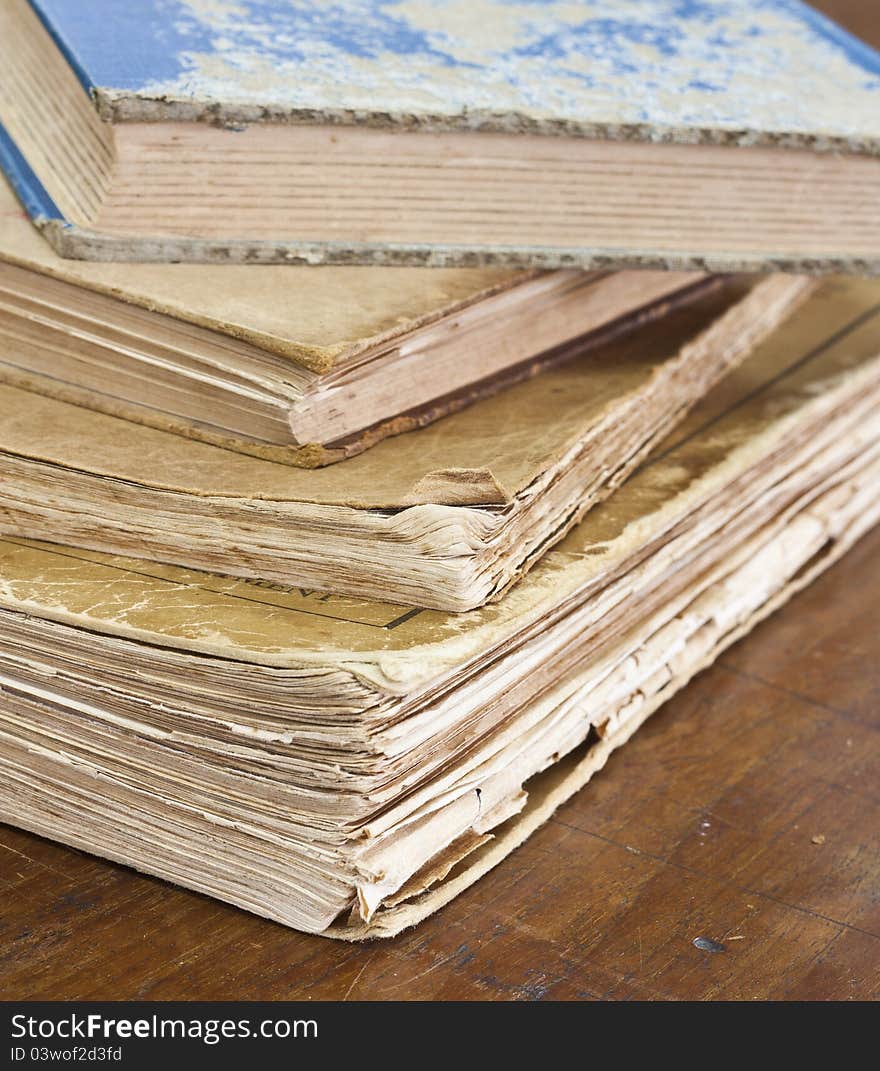 Stack of old books on wooden table