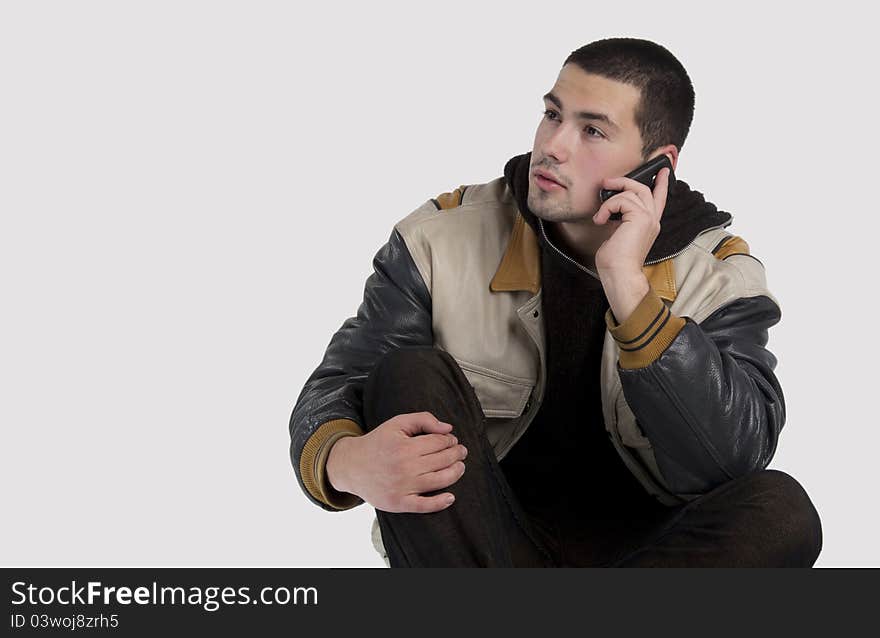 Portrait of a handsome young man talking on mobile phone