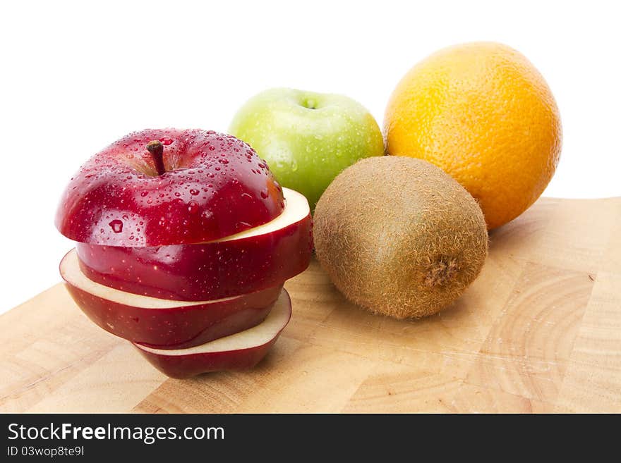 Red and green apple, orange, kiwi on wood plate. Red and green apple, orange, kiwi on wood plate.