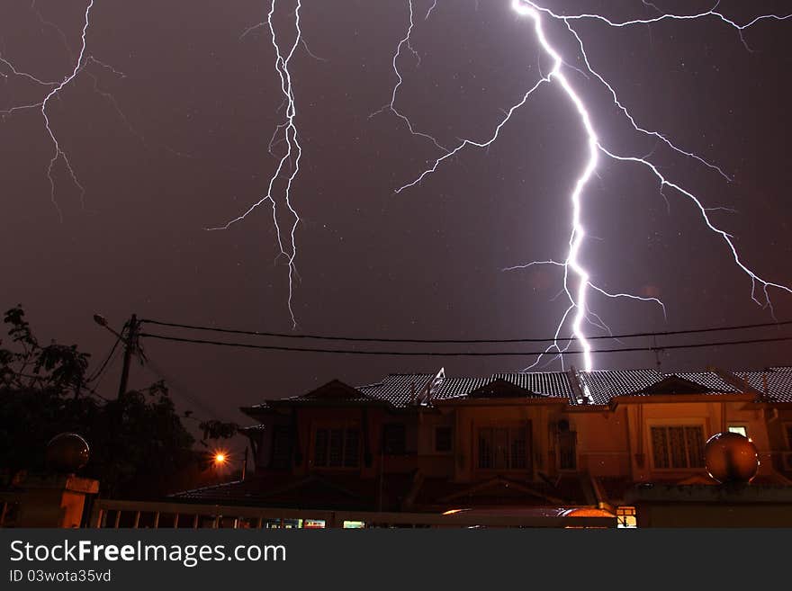 Lightnings over a residential during a thunderstorm at night. Lightnings over a residential during a thunderstorm at night