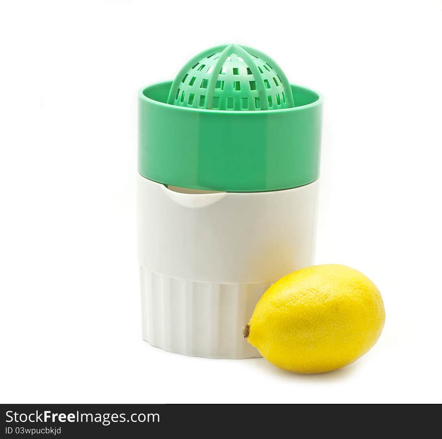 Green juicer and one lemon on white background