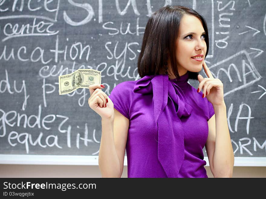 Caucasian woman with dollar note thinking