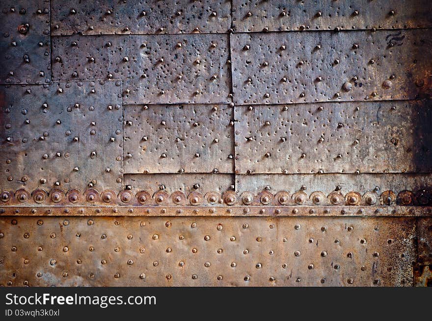Rivets and ornament on old rusty metal door. Rivets and ornament on old rusty metal door