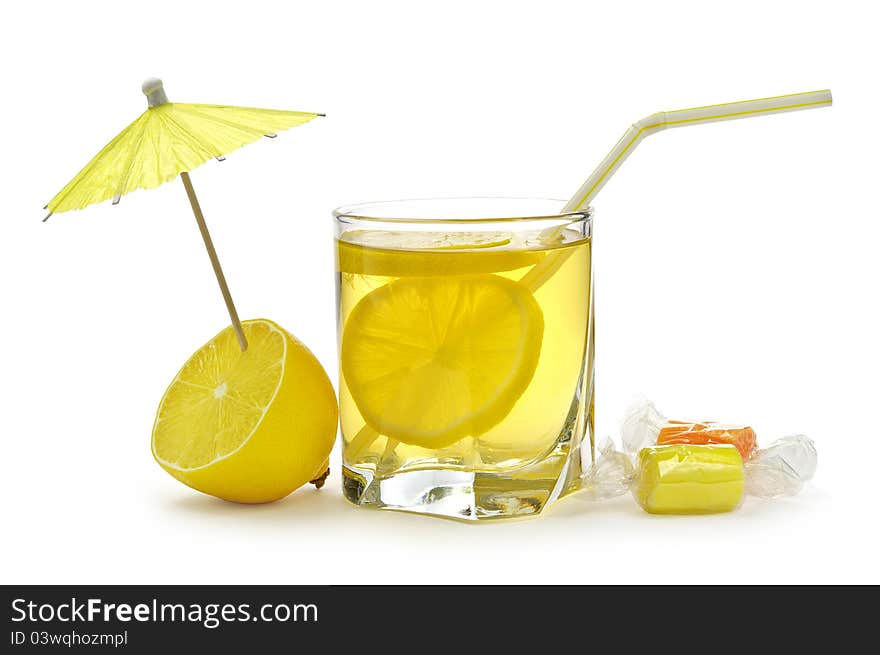 Glass of juice with lemons on a white background