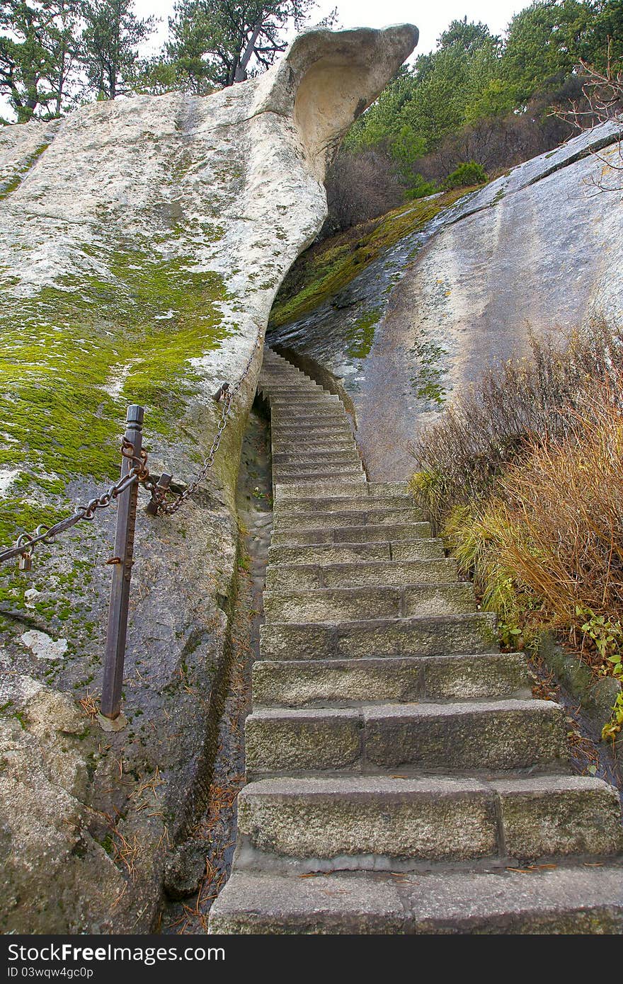 The dangerous way in Mount Hua(Huashan). Huashan is one of the most perilous tourist attractions in china. Huashan is located in Huayin, Shaanxi, China. The dangerous way in Mount Hua(Huashan). Huashan is one of the most perilous tourist attractions in china. Huashan is located in Huayin, Shaanxi, China.