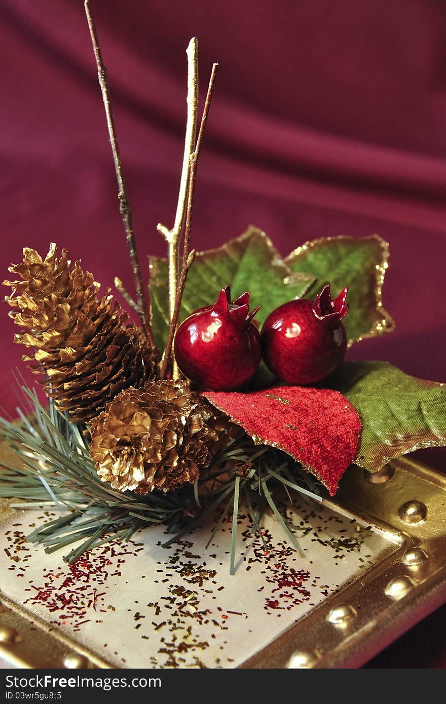 Christmas arrangement with cones, twigs and berries on the plate