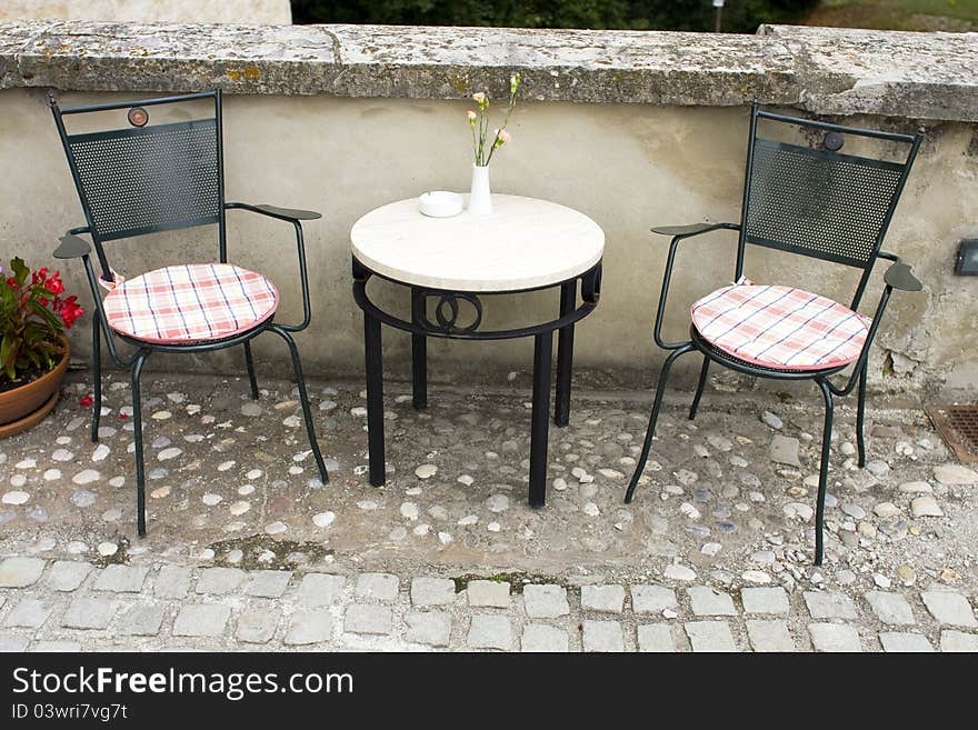 Two empty chairs and small table with decoration. Two empty chairs and small table with decoration.