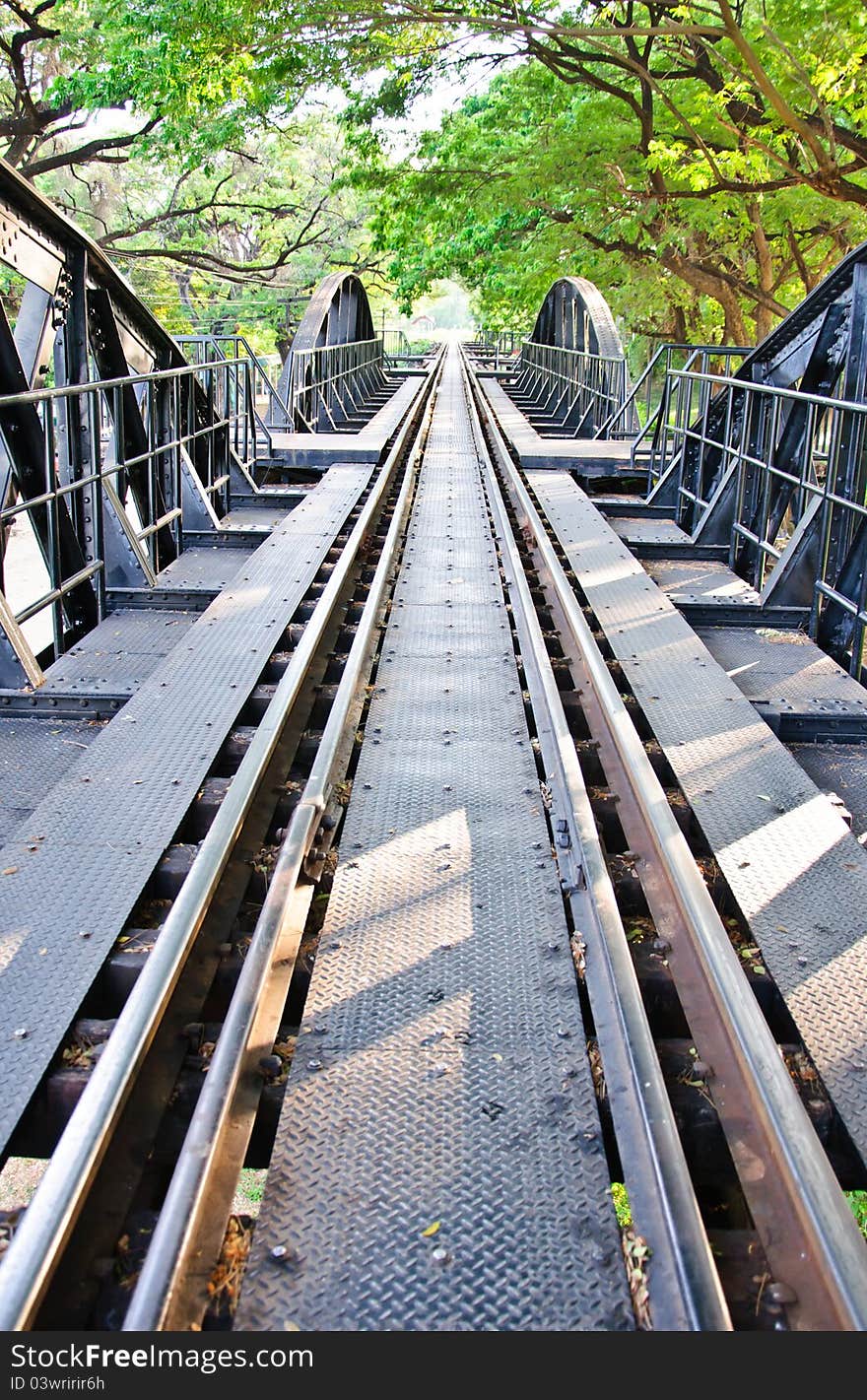 Straight railway River Kwai Bridge under green tree. Straight railway River Kwai Bridge under green tree