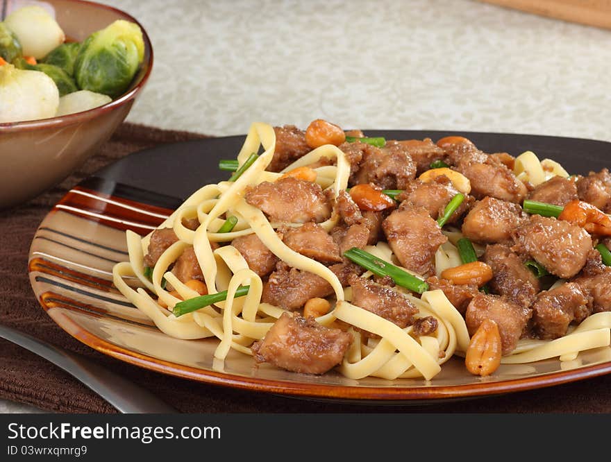 Chicken cashew with noodles on a dinner plate. Chicken cashew with noodles on a dinner plate