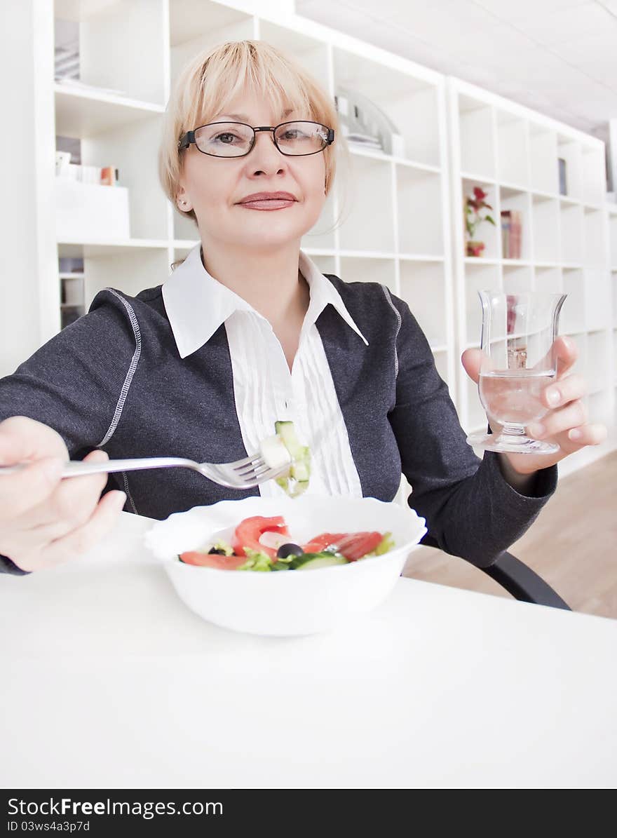 Adult Blonde Woman In Glasses Eats Salad