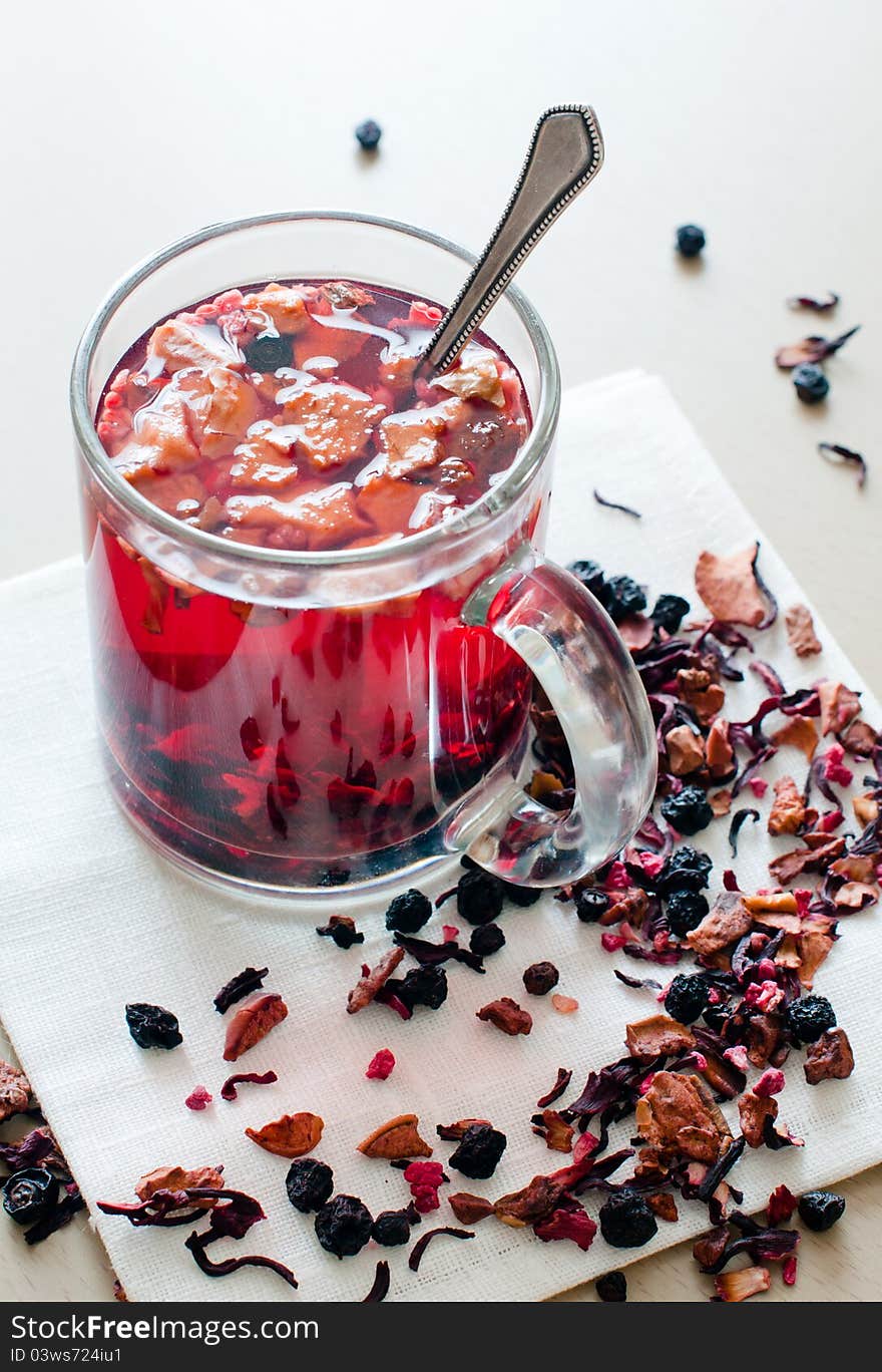 Hot vitamin drink from dried fruits and berries in a transparent cup.