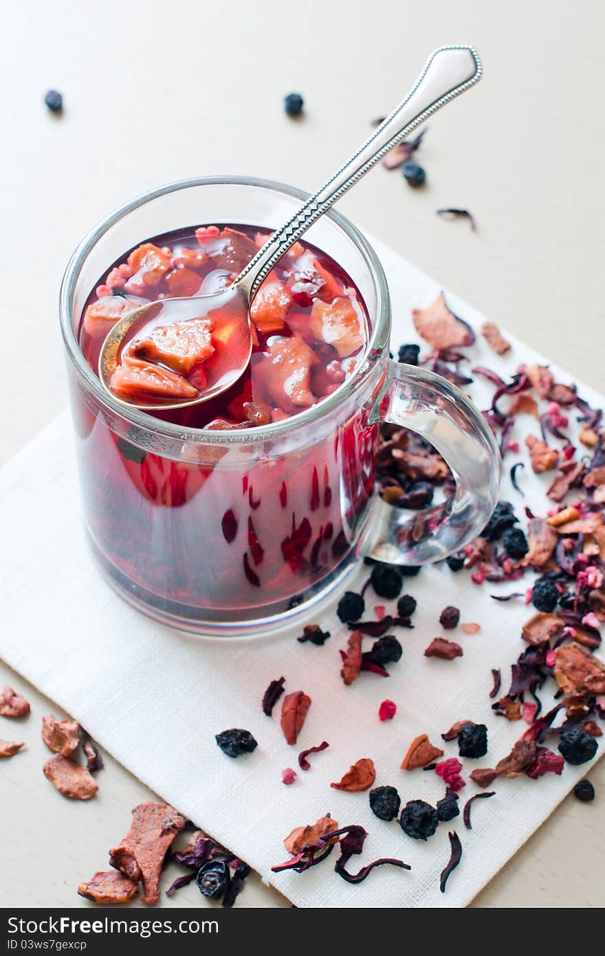 Hot vitamin drink from dried fruits and berries in a transparent cup.