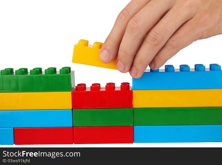 Close up of child toy bricks construction isolated on white background