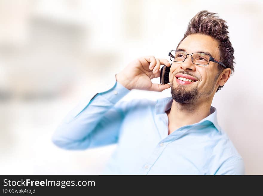 Handsome young man talking on cell