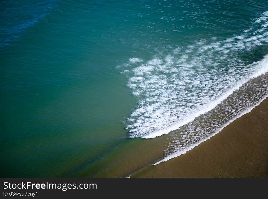 Cool blue color of ocean with few waves and send. Cool blue color of ocean with few waves and send