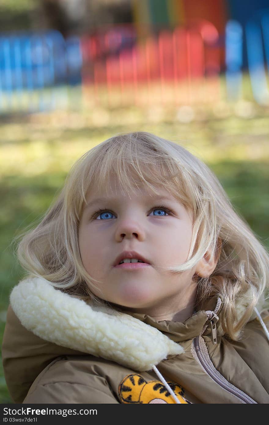 Little blue-eyed and snub girl looking at something upward. Little blue-eyed and snub girl looking at something upward