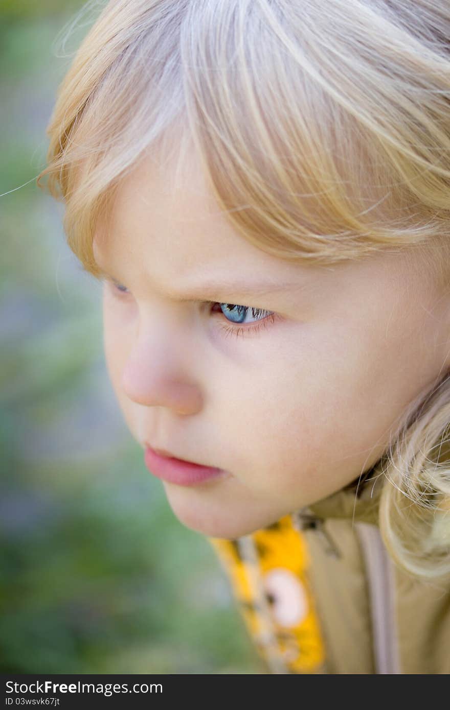 Little blue-eyed girl looking at something. Little blue-eyed girl looking at something