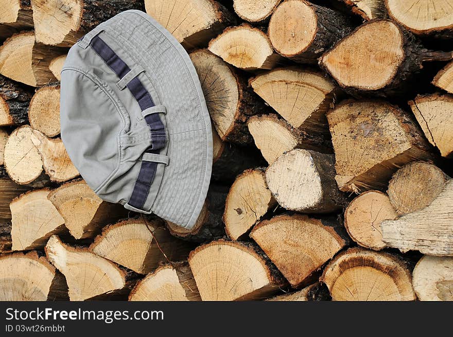 Stack of Firewood and Hat