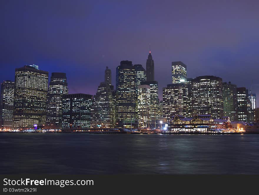 A view of downtown Manhattan from Brooklyn Heights, including the financial district and South Street Seaport on a clear evening. A view of downtown Manhattan from Brooklyn Heights, including the financial district and South Street Seaport on a clear evening.