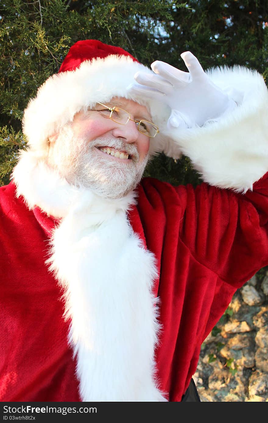 Santa holding his hand over his eyes peering into the distance. Santa holding his hand over his eyes peering into the distance.