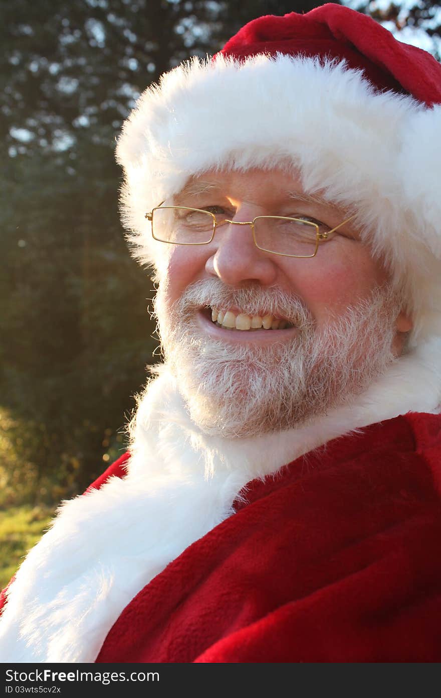 Smiling Santa turning to look at the camera on this sunny winter day.