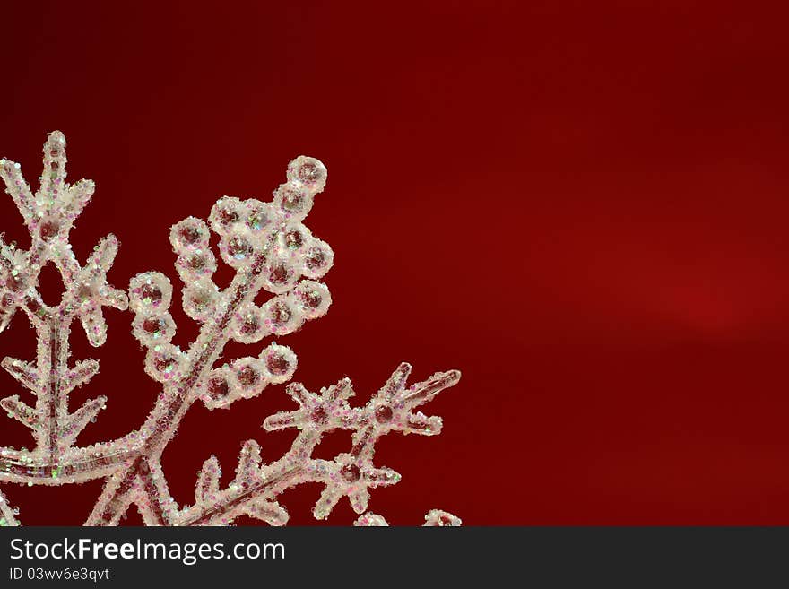 A glittering Christmas Snow Flake against a red back ground. A glittering Christmas Snow Flake against a red back ground.