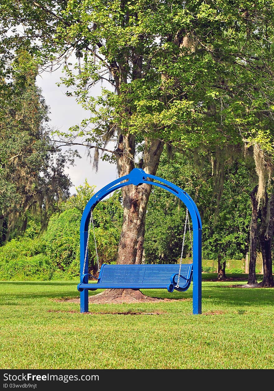 Vertical View Of A Rocking Bench Painted Blue.