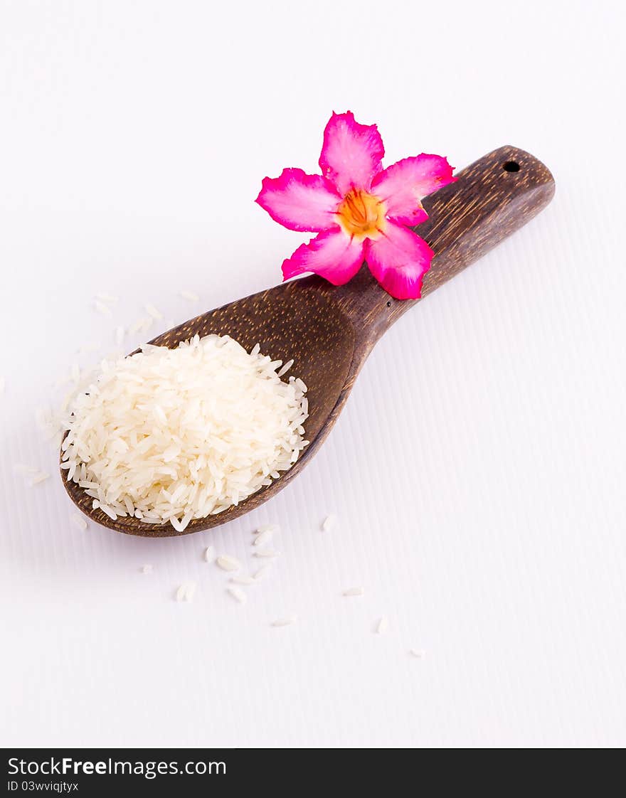 Raw rice and wooden spoon