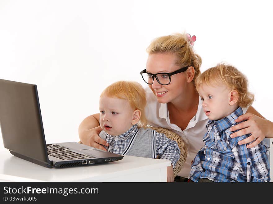 Baby Sitter with two children looking at laptop. Baby Sitter with two children looking at laptop