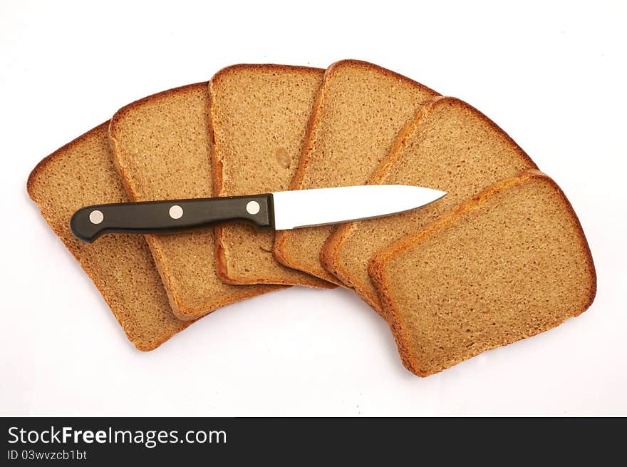 Cut bread with a knife on a white background