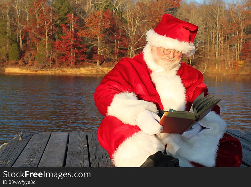 Santa Reading On The Dock