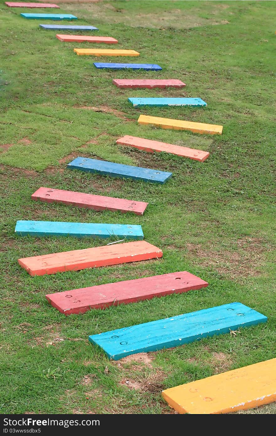 Colorful Wooden Walkway and Pathway in the Green garden grass fields