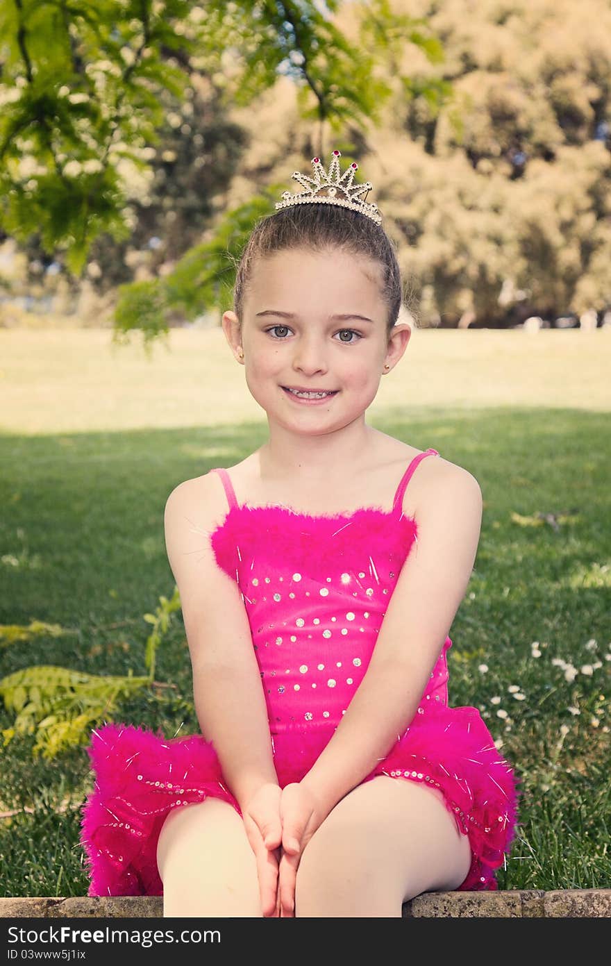 Vintage style portrait of a little ballerina sitting on a brick wall. Vintage style portrait of a little ballerina sitting on a brick wall.