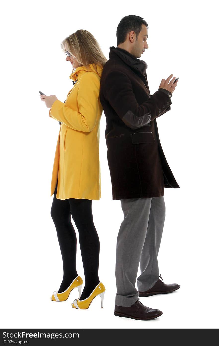 Man and women checking their cellular phones for messages. Man and women checking their cellular phones for messages