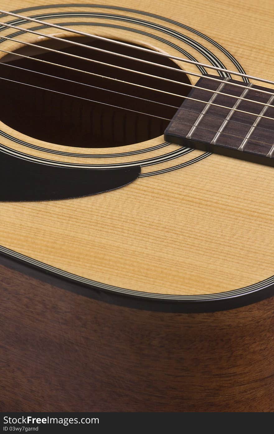 Closeup view of guitar sound hole, strings, and pick guard. Closeup view of guitar sound hole, strings, and pick guard