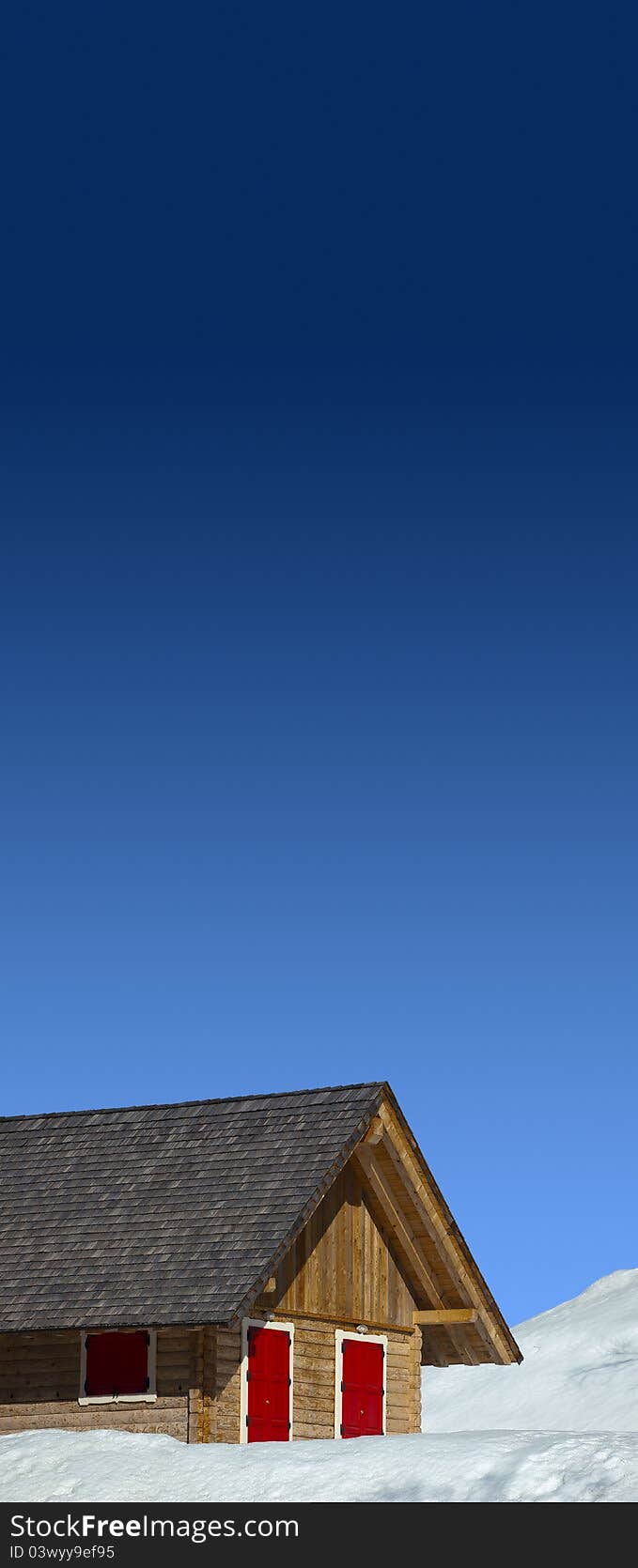 Mountain wood chalet with red windows and blue sky. Mountain wood chalet with red windows and blue sky