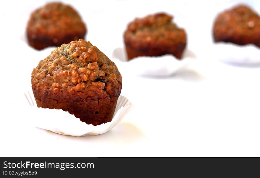 Brown muffins rich in nuts and cacao as shown in their textured outer layer. Brown muffins rich in nuts and cacao as shown in their textured outer layer