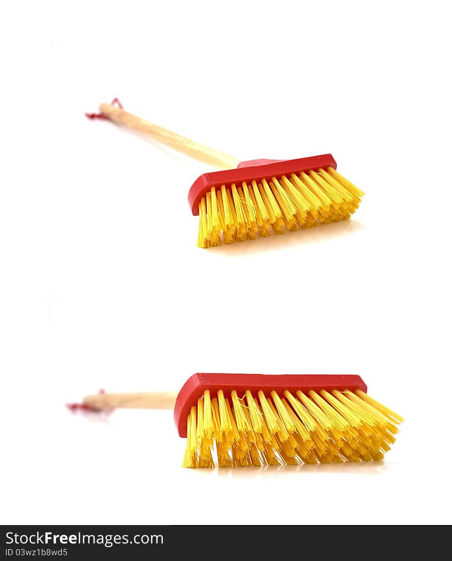 A small mop that is made exclusively for children to play with as a toy. A small mop that is made exclusively for children to play with as a toy