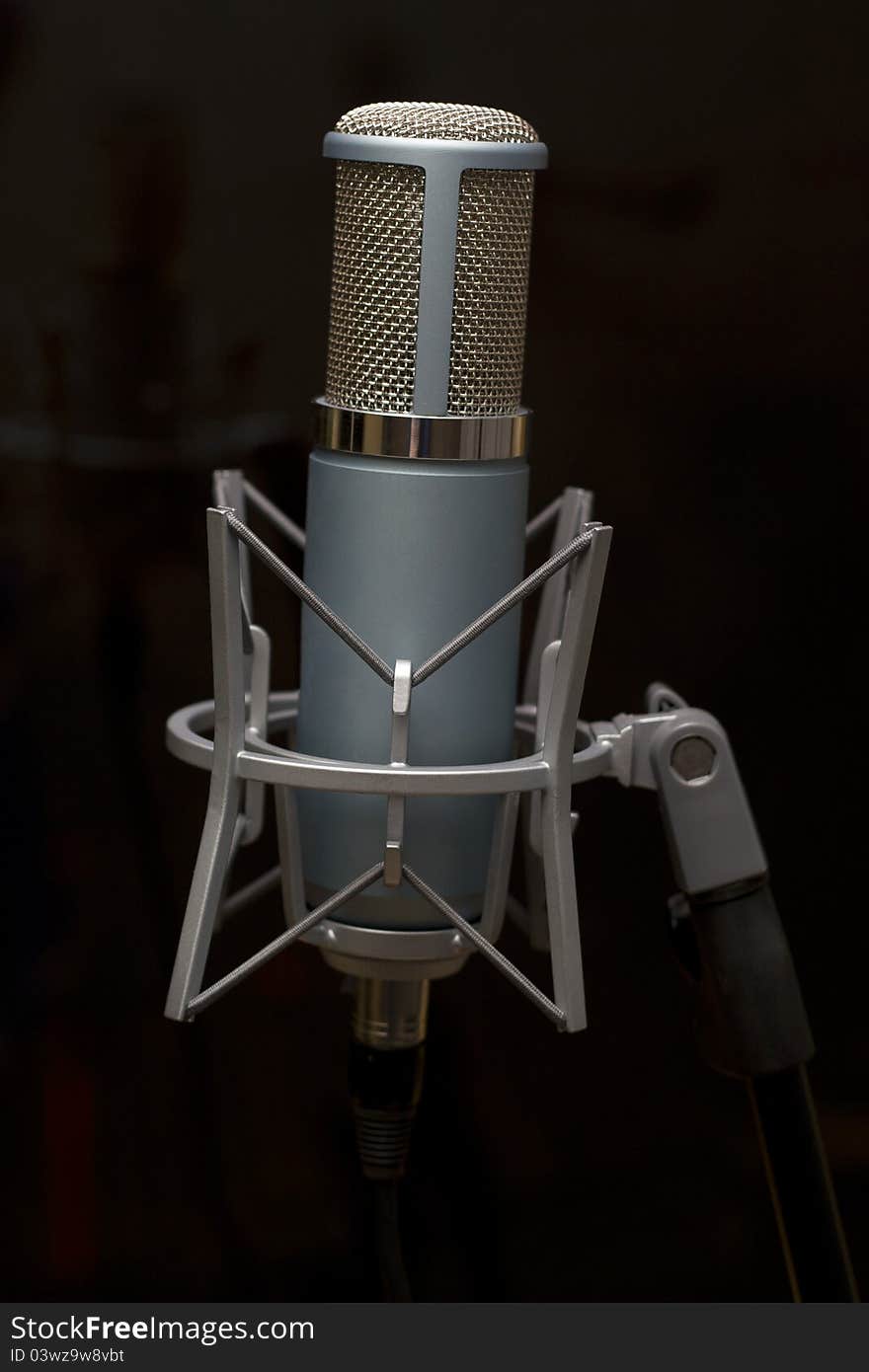 Studio microphone on a tripod in the music studio. Studio microphone on a tripod in the music studio