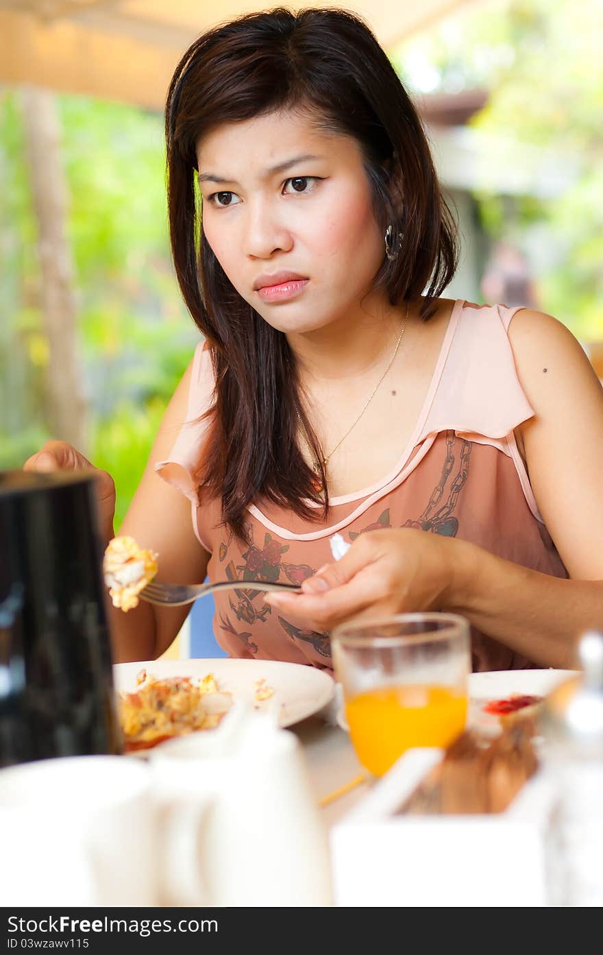 A girl look serious during her food