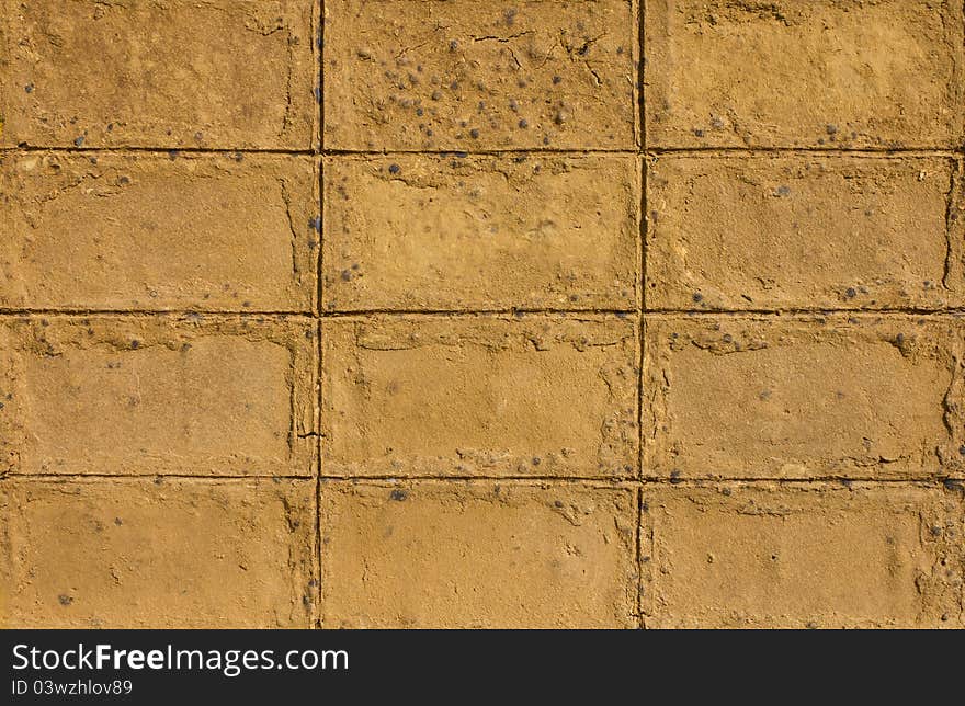 Walls of brown clay. Which made the walls of the house.