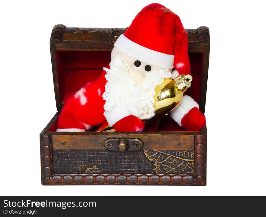 Toy santa klaus in an antiquarian chest on a white background