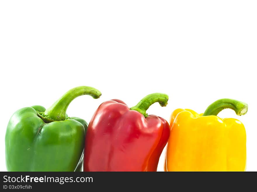 Red, yellow and green bell peppers isolated on the white backgro