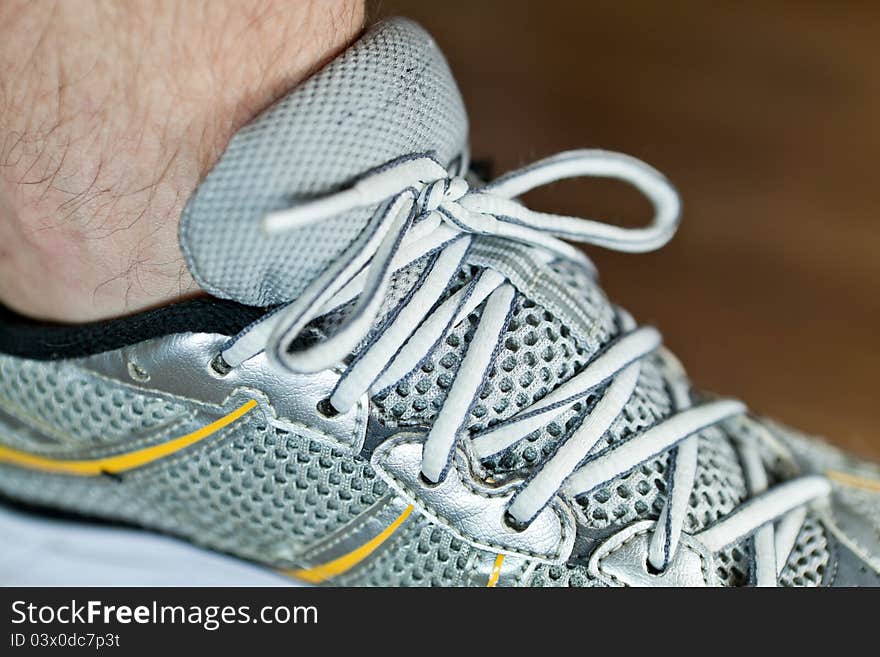 Man tying sports shoe at gym before workout. Man tying sports shoe at gym before workout