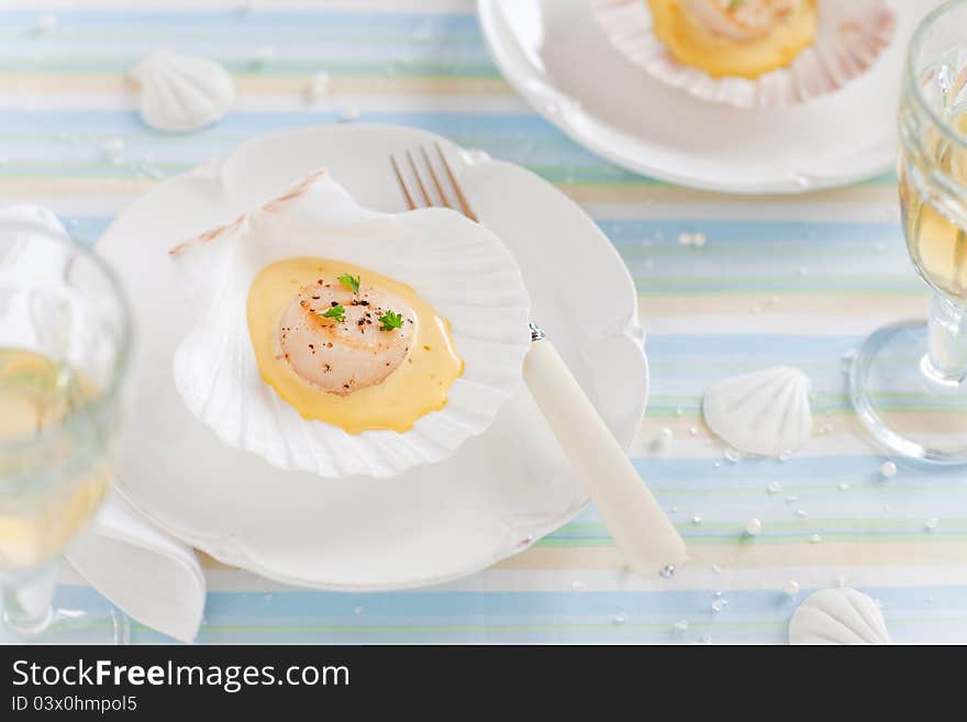 Scallops with saffron sauce on seashell