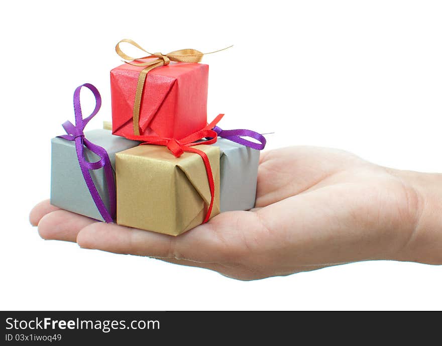 Hands presenting several colourful gift boxes